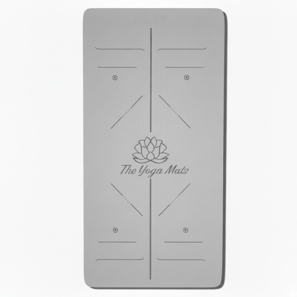Extra large charcoal gray TPE yoga mat with alignment lines and a central lotus flower logo.