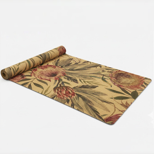 An unrolled cork yoga mat featuring a botanical or floral print.