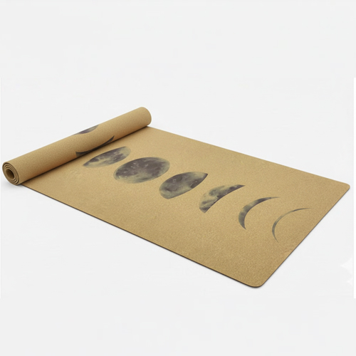 An unrolled cork yoga mat with moon pattern