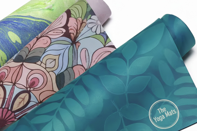 A partially unrolled yoga mat with a vibrant, colorful custom printed tie-dye design.