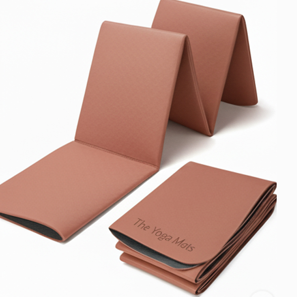 light pink foldable travel yoga mat, displayed in both an open and a compact, folded state.