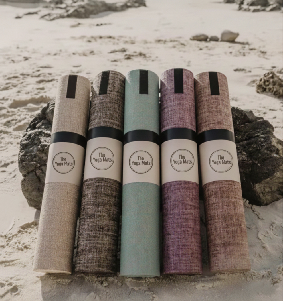 A collection of colorful, eco-friendly jute yoga mats, representing a yoga mat brand scaling up to a bulk order.