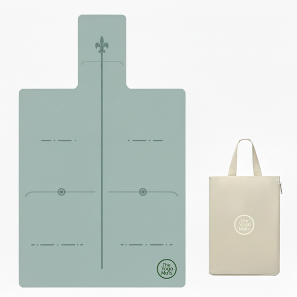 A sage green Pilates reformer mat with alignment lines, shown with a custom logo tote bag.