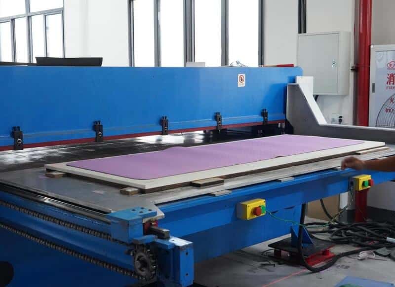 Precision die-cutting machine for custom yoga mat dimensions.