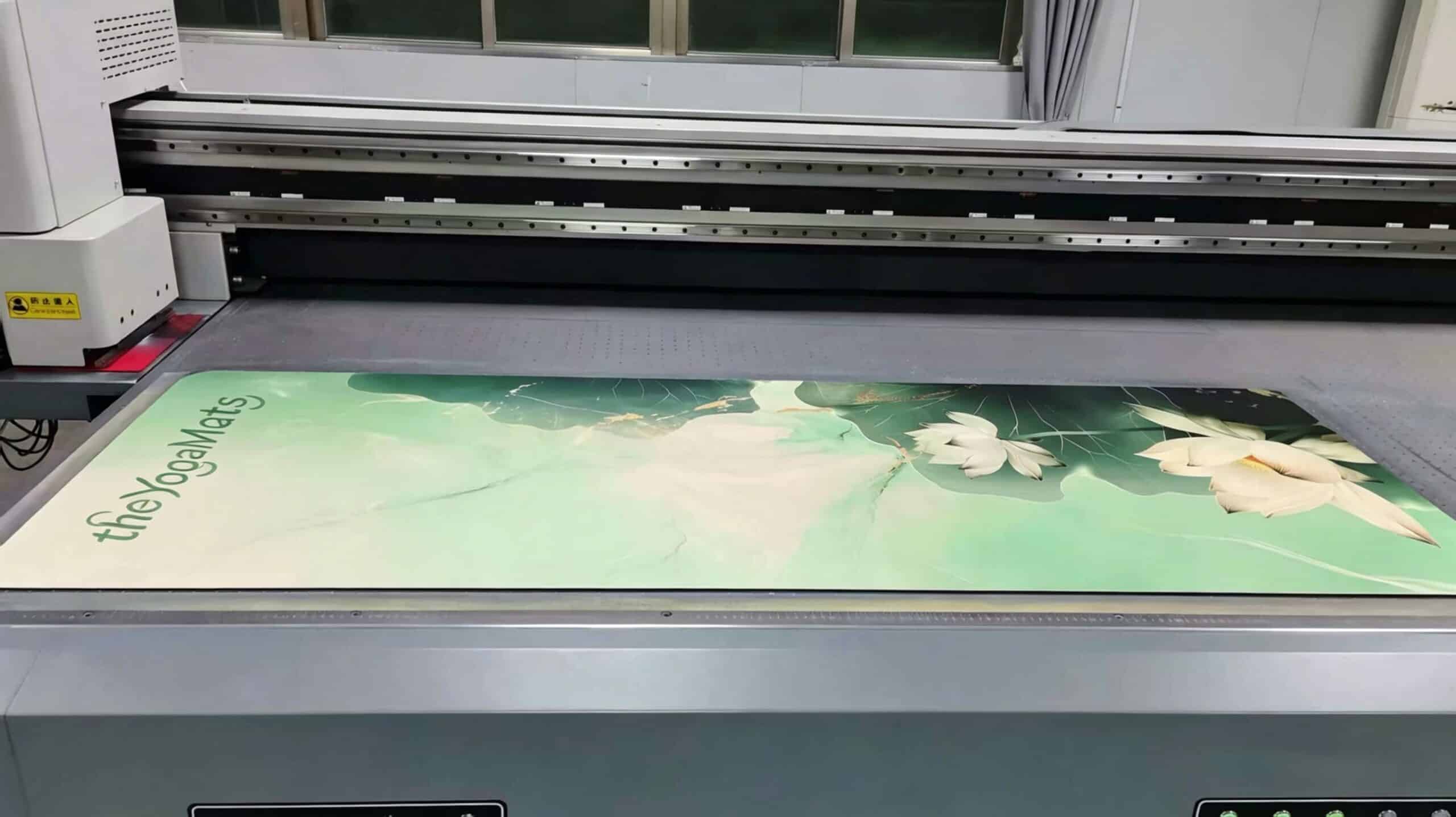 New advanced latex printing machine in operation at Theyogamats factory creating vibrant and eco-friendly floral designs.