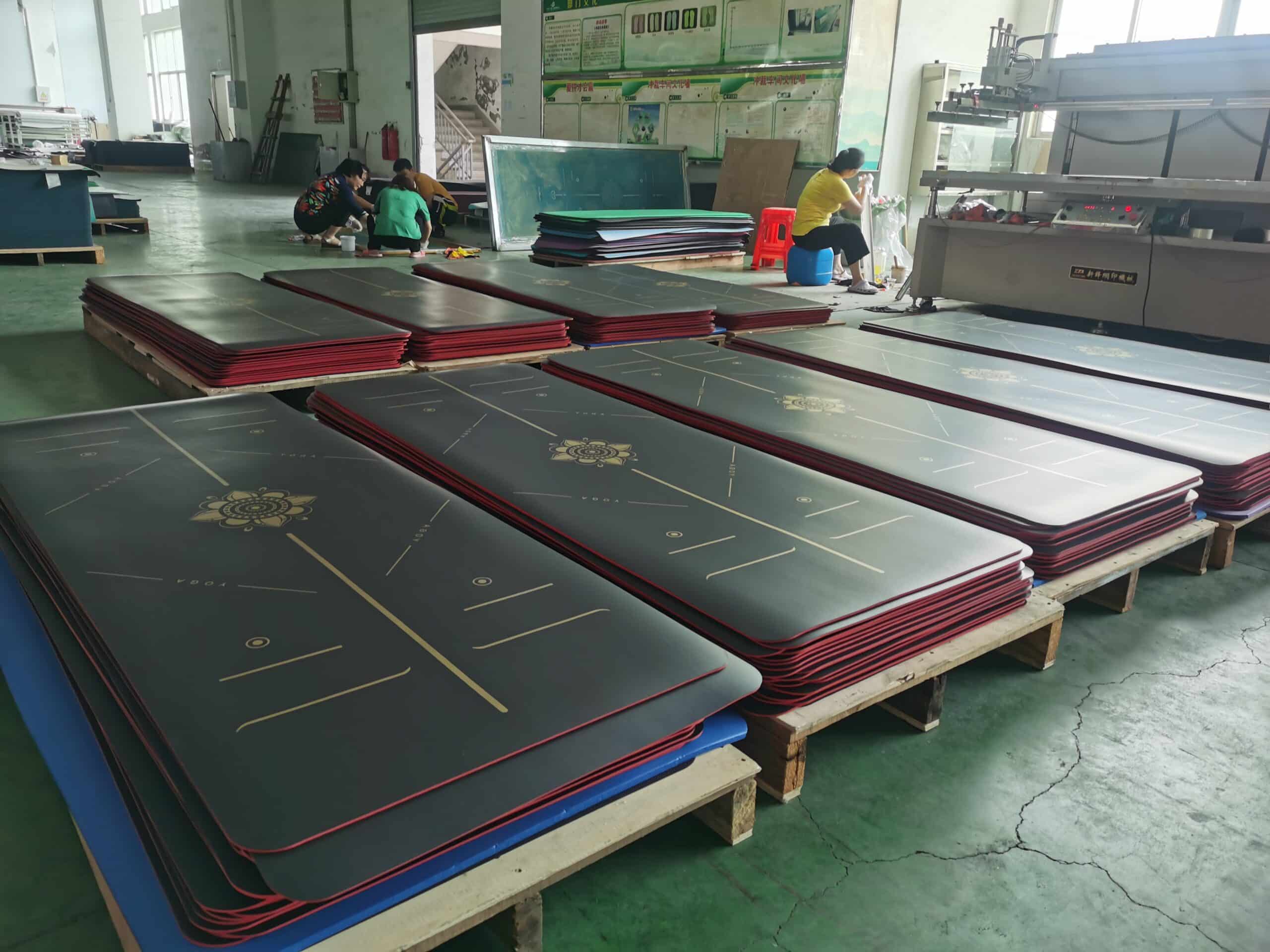 Large scale production of rubber yoga mats using heat-pressing bonding technology.
